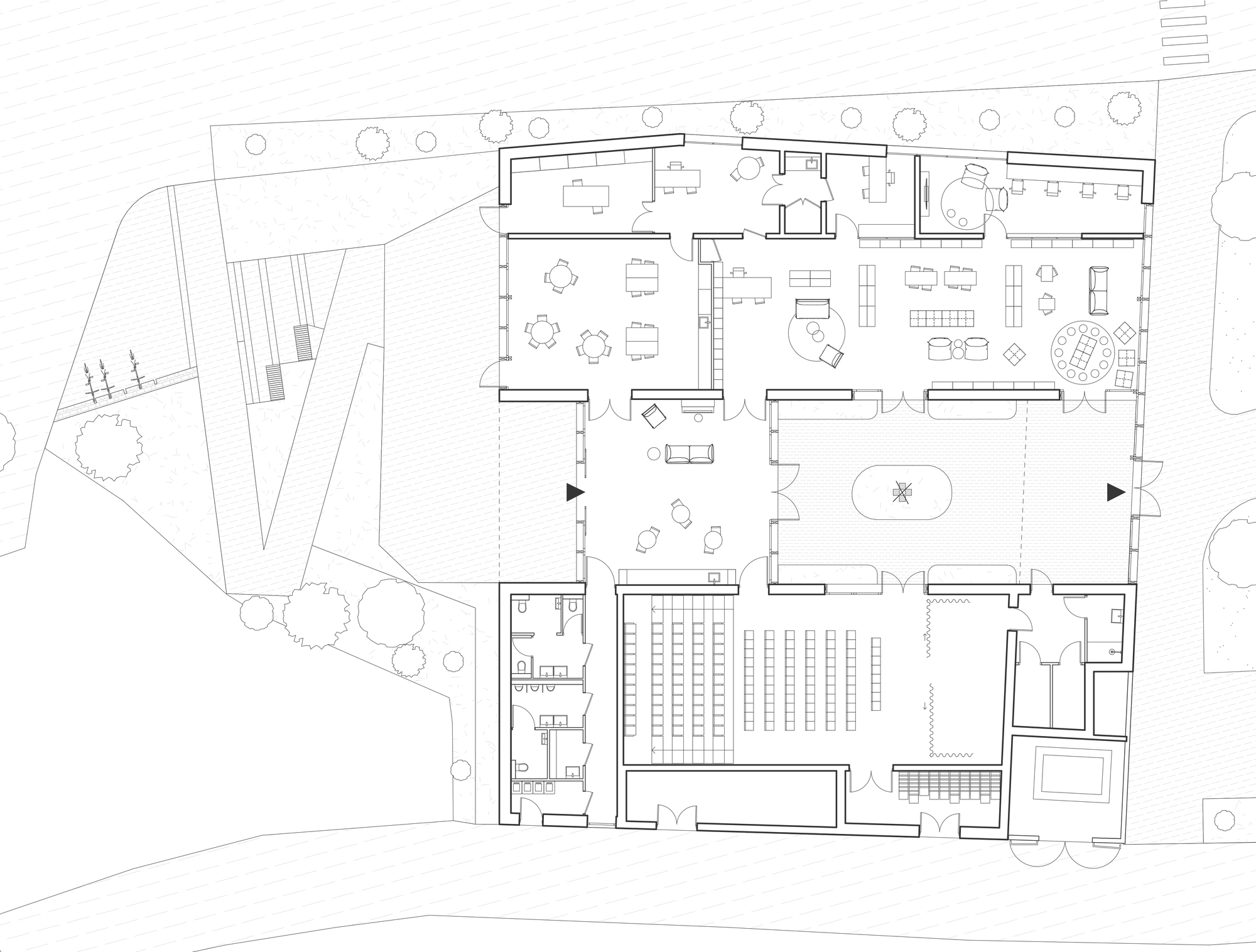 Floor plan drawing showing rooms arranged around a central courtyard, with a tiered seating hall, reading areas, offices and washrooms