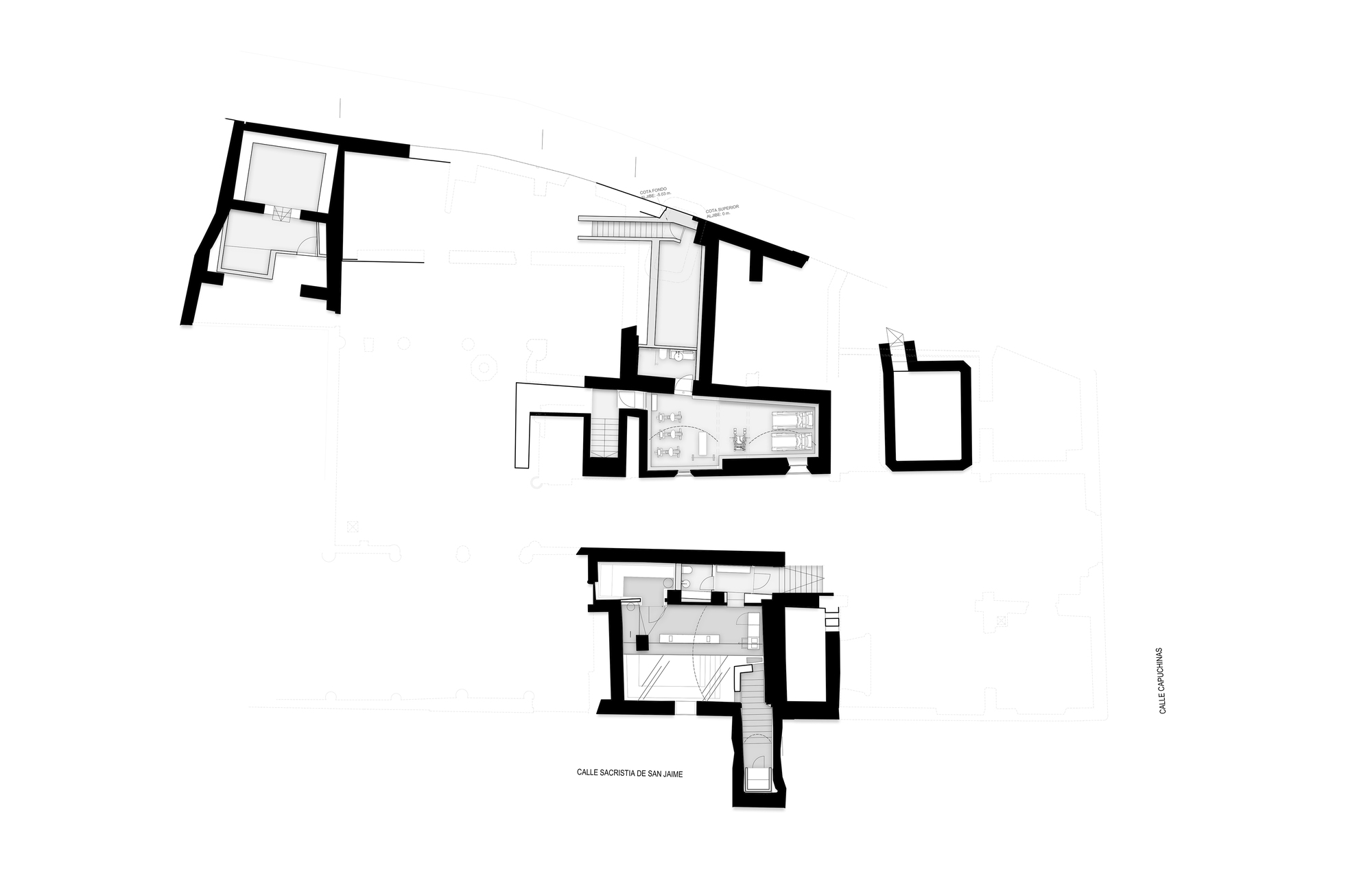Site plan drawing of scattered small building footprints with thick black walls, drawn between two labelled streets