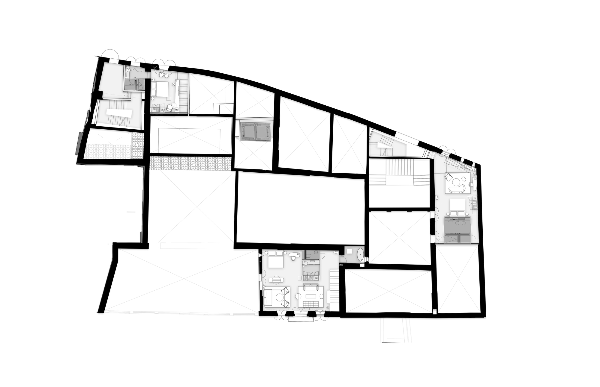 Second floor plan drawing with a few furnished suites and many unfurnished rooms of heavy walls around a central void
