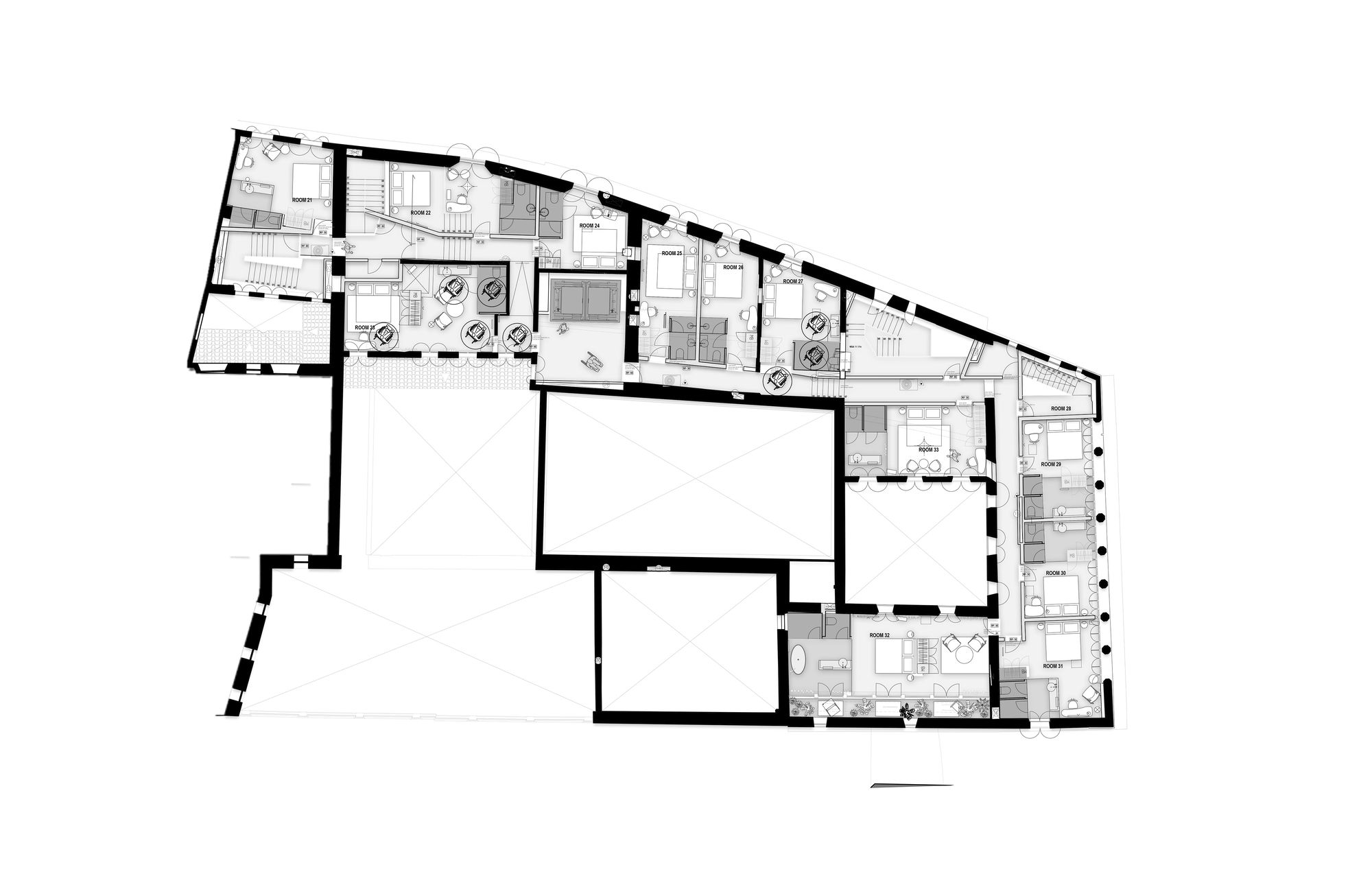 Upper floor plan drawing of an irregular wedge-shaped building with guest rooms ringing open courtyards and roof voids