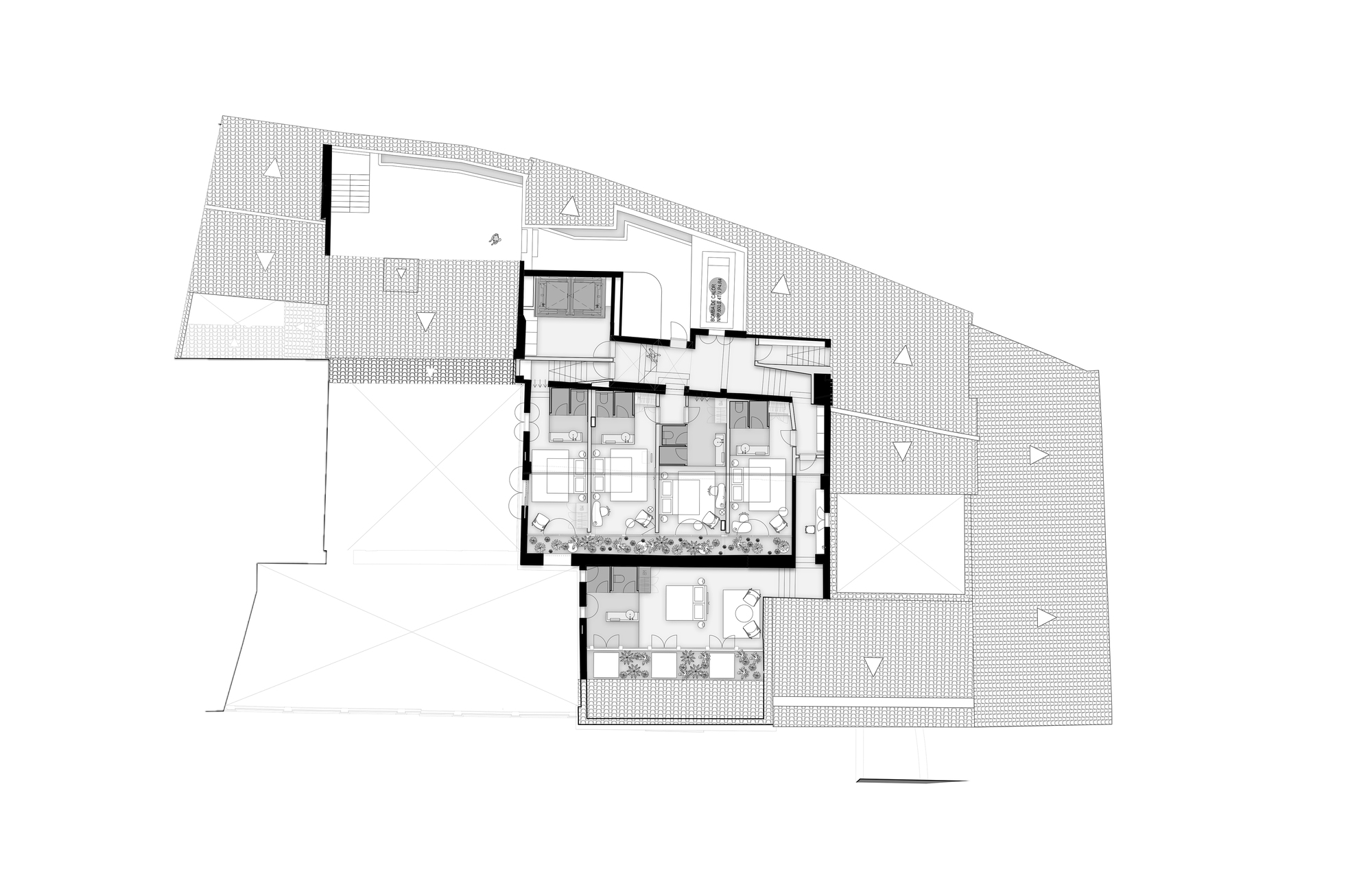 Top floor plan drawing showing a small cluster of guest rooms with terraces, surrounded by hatched pitched roofs and a rooftop pool