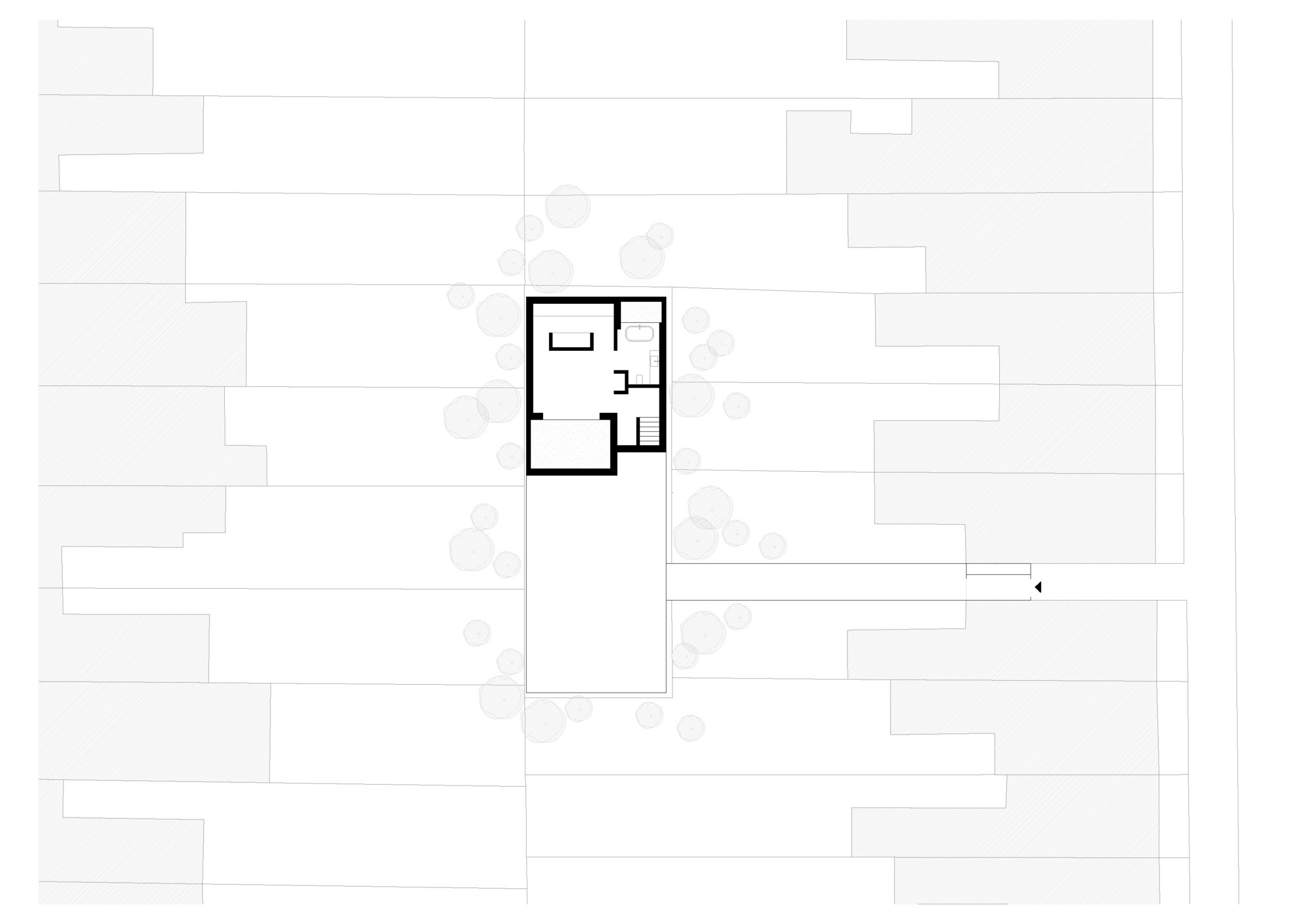 Upper floor plan drawing showing a bedroom, bathroom and stair in the smaller volume, with a roof area below to the south