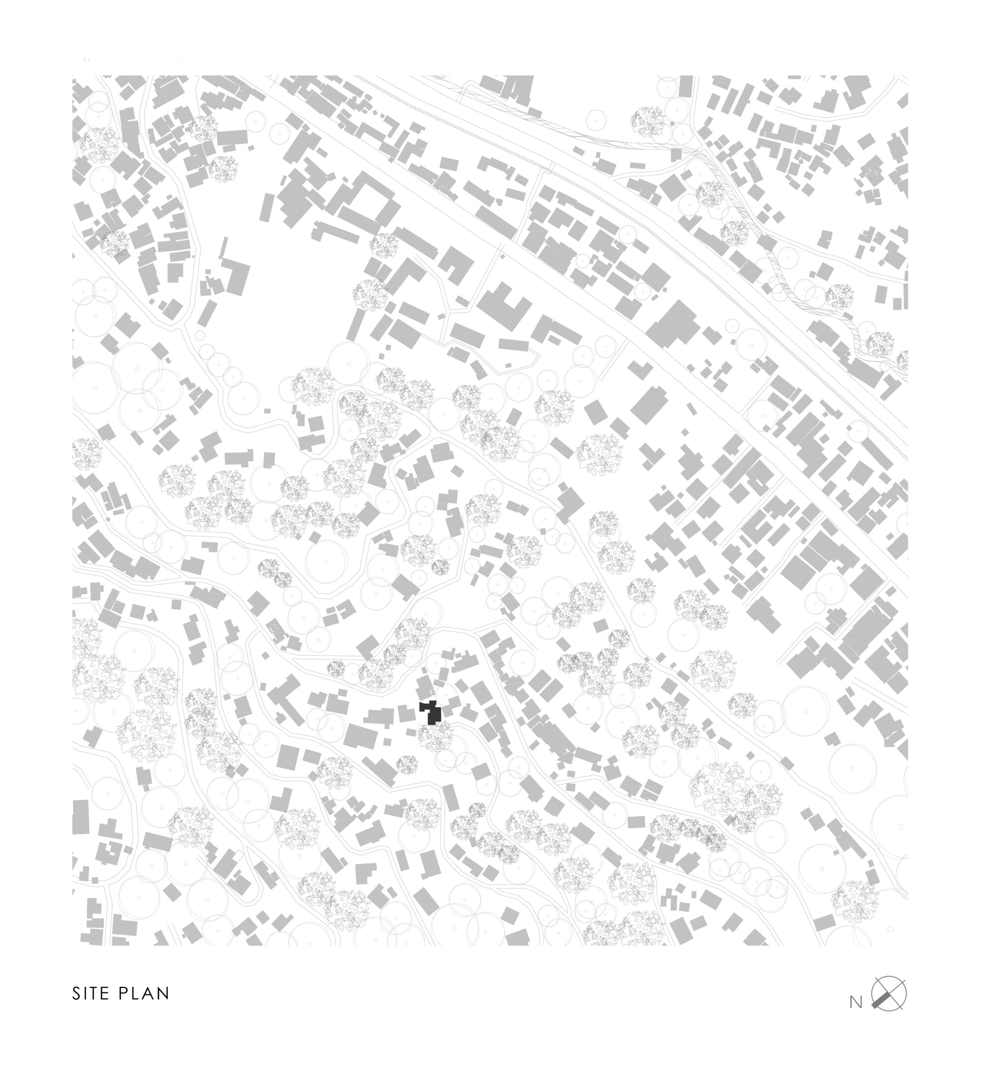 Site plan drawing showing a single dark building footprint among scattered houses, tree canopies and winding roads, with a north arrow