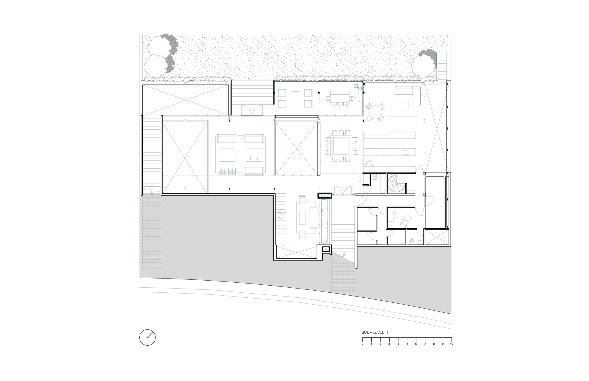 Sub-level floor plan drawing showing living and dining rooms, bedrooms and service rooms arranged around two open courtyards beside a curved lower road