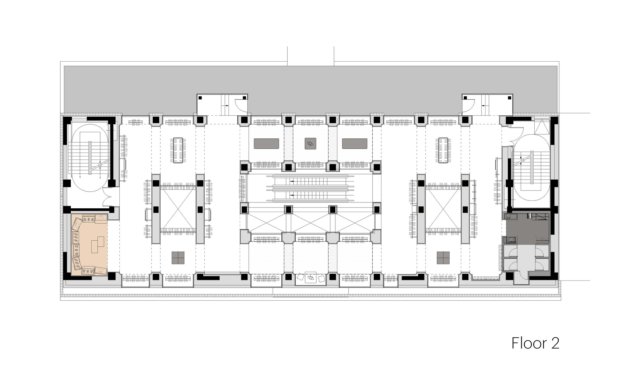 Second floor plan drawing showing a central escalator bank, two oval stair cores and a tinted lounge room at the left corner