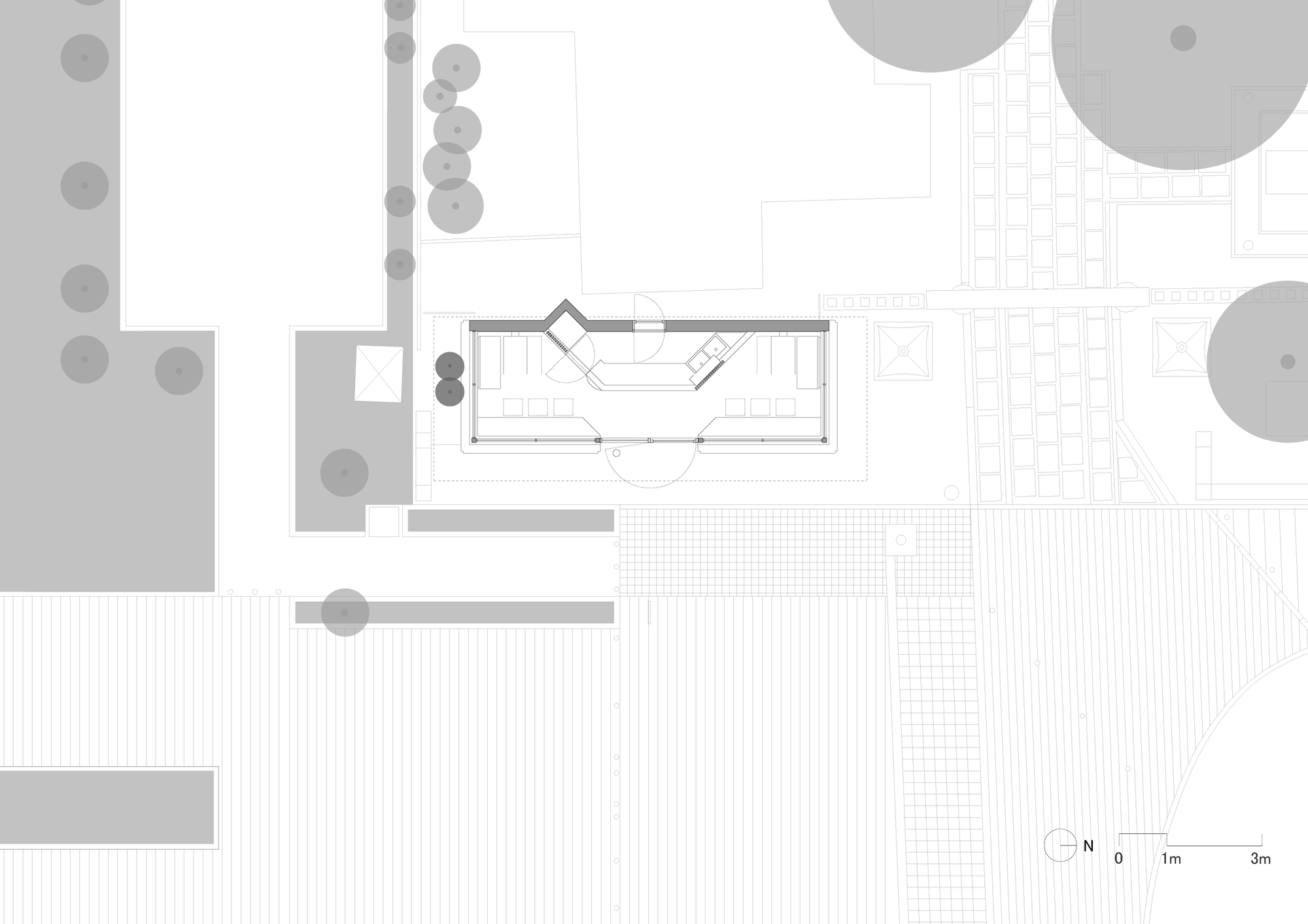 Plan drawing of the narrow pavilion within its surroundings, with paving, tree canopies and neighboring structures marked at a metric scale