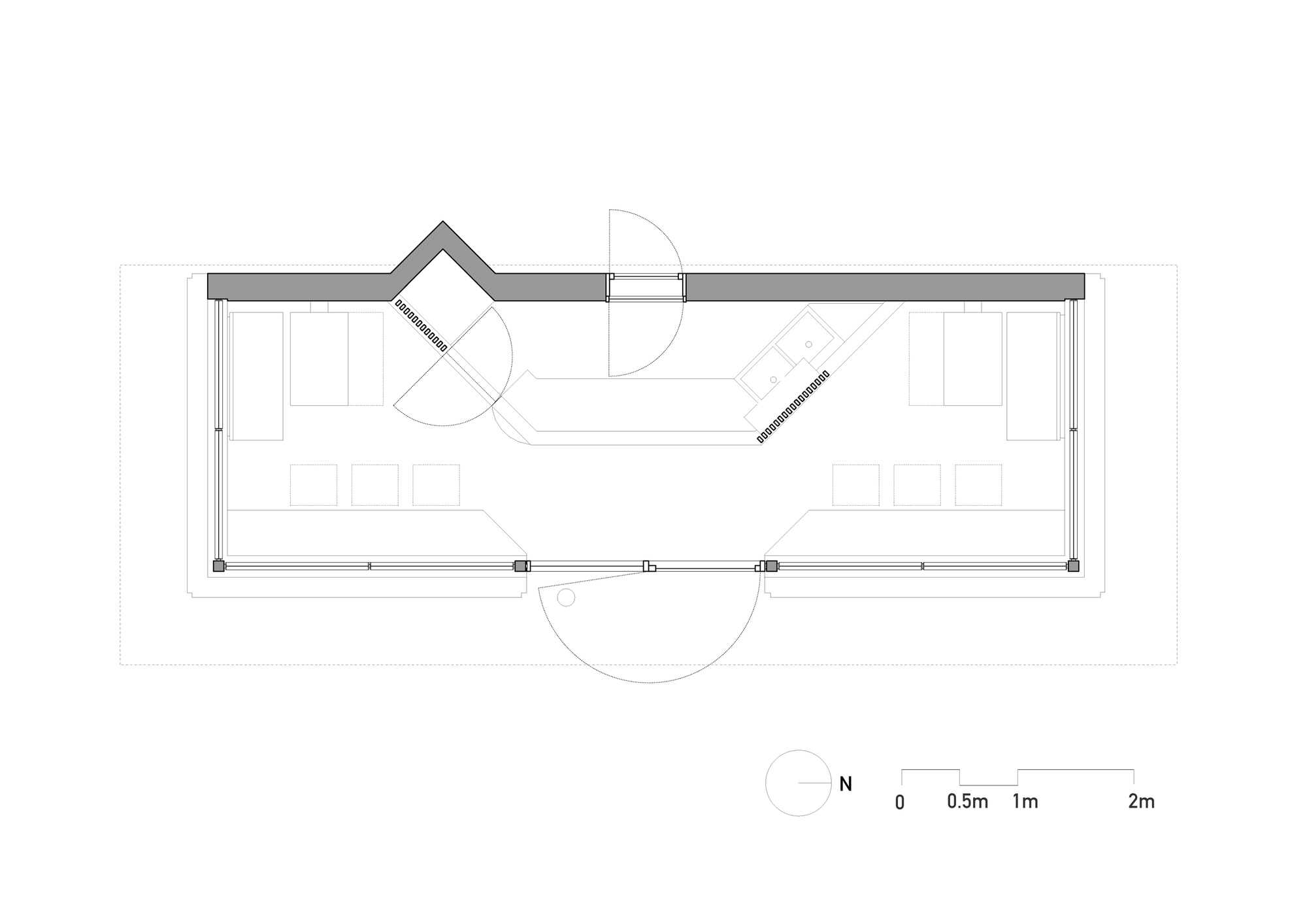 Floor plan drawing of the narrow pavilion showing a central counter, benches along both ends, and a kinked north wall with swing doors