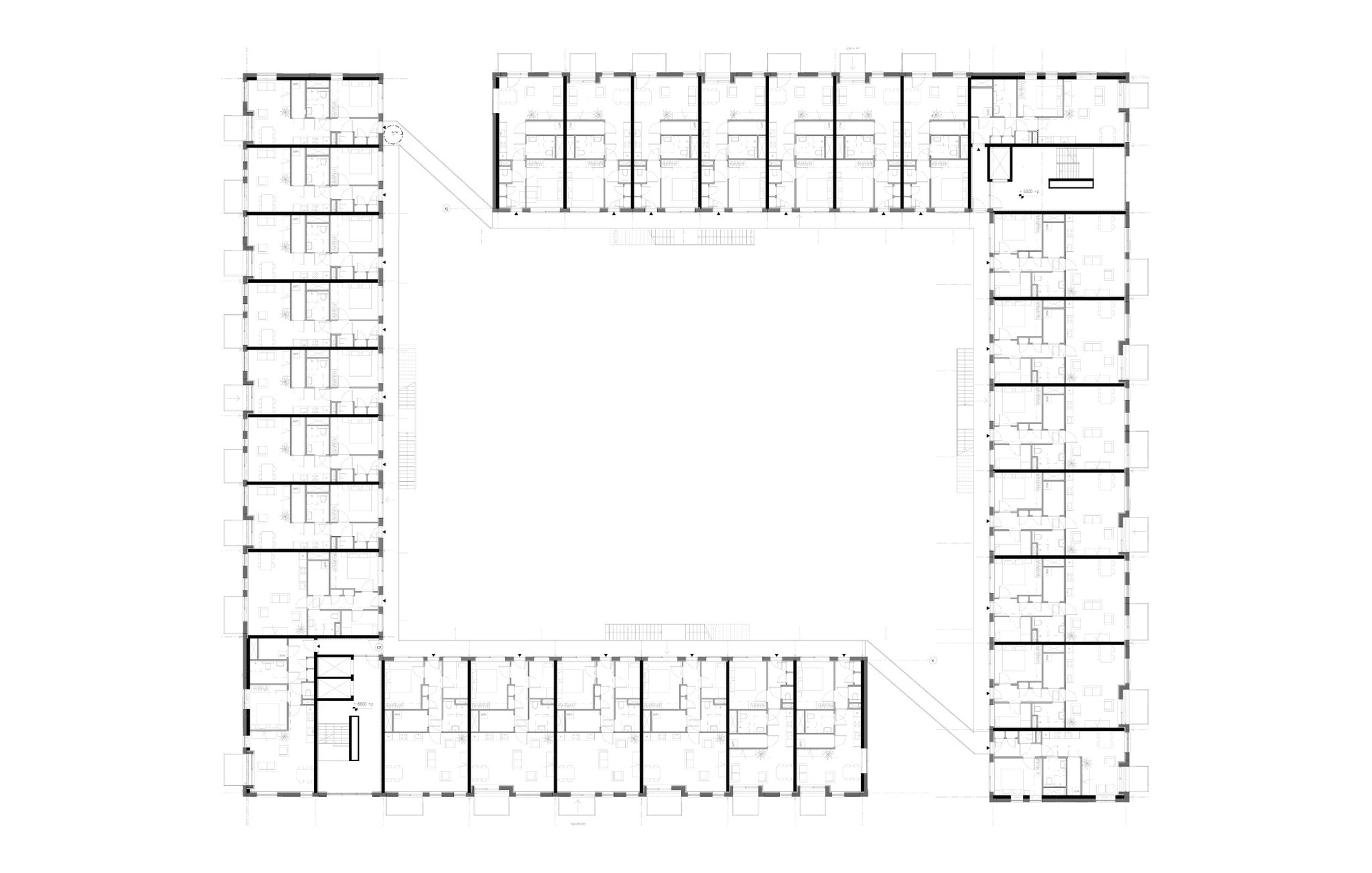 Upper floor plan drawing of a U-shaped ring of apartments with repeated unit layouts around an open void
