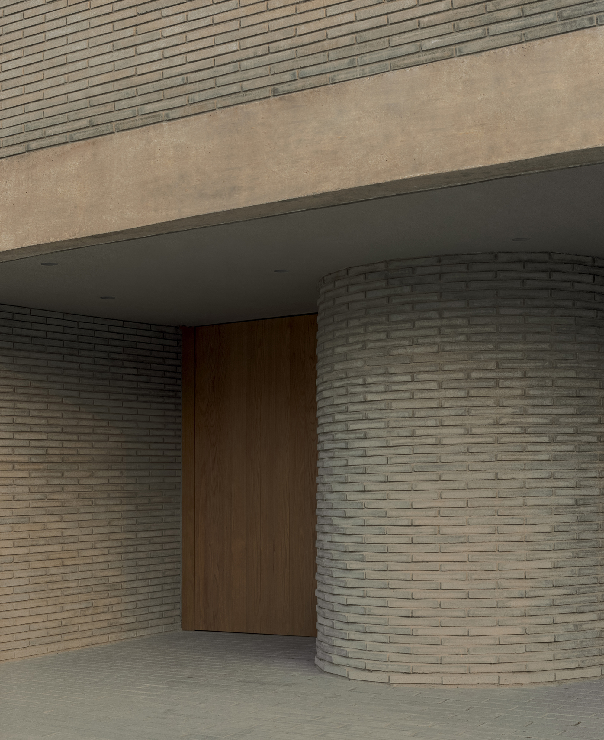 Entrance recess with a curved brick wall beside a tall timber pivot door, under a concrete soffit with downlights