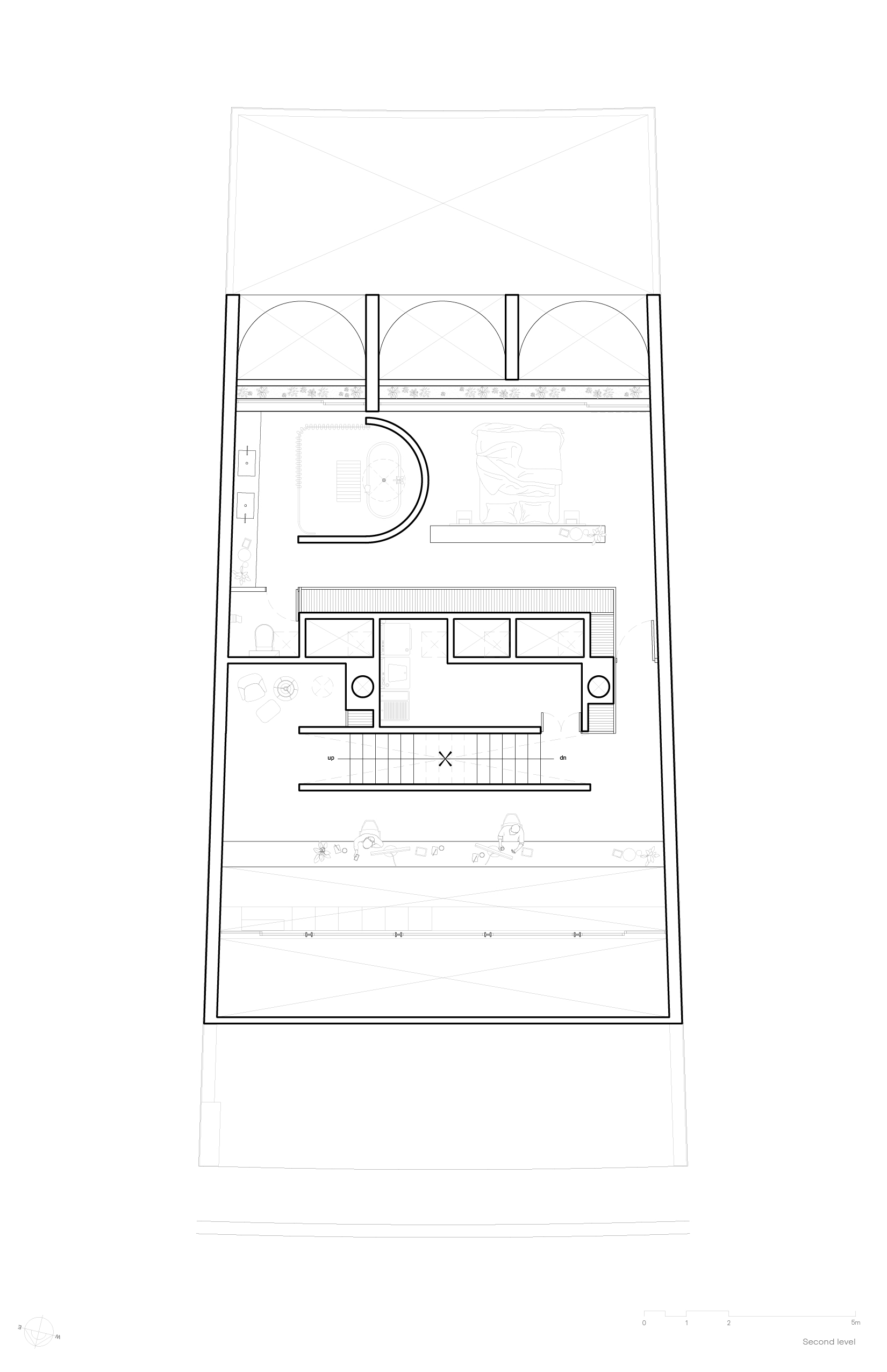 Second level floor plan drawing showing an arched loggia, a curved wall, a central stair and service cores within thick perimeter walls