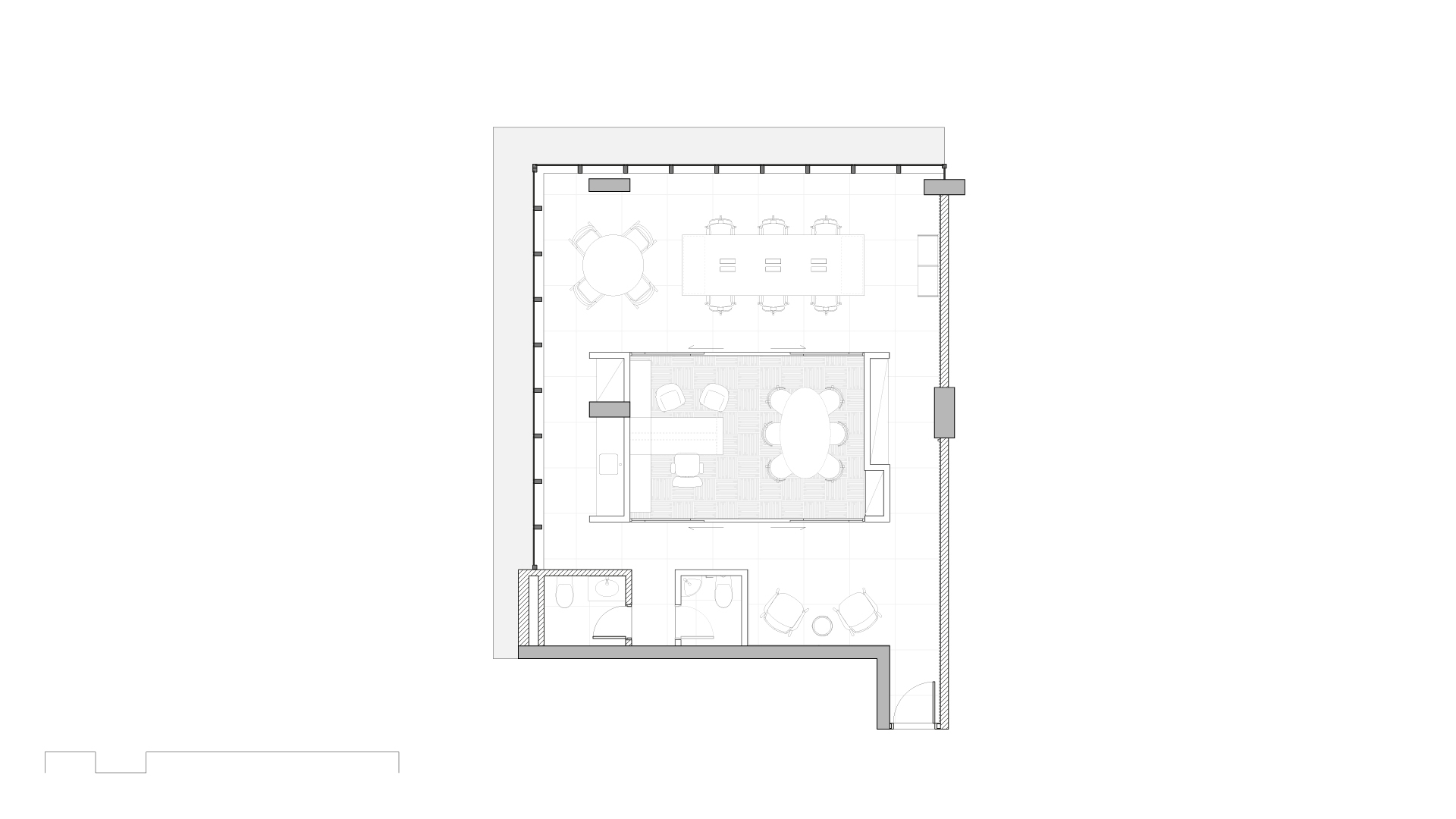 Floor plan drawing showing a central glazed meeting volume, perimeter workstations, restrooms and a seating area within an L-shaped floor