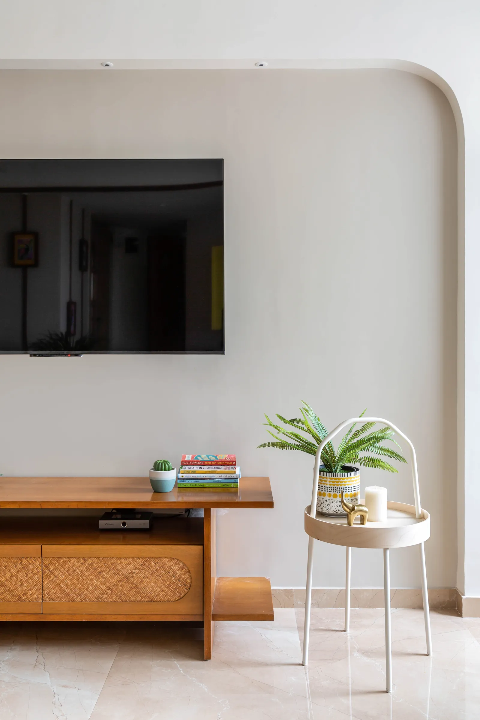 The TV unit is a refurbished piece of furniture with rattan details adding to the charm. Anuja Kambli