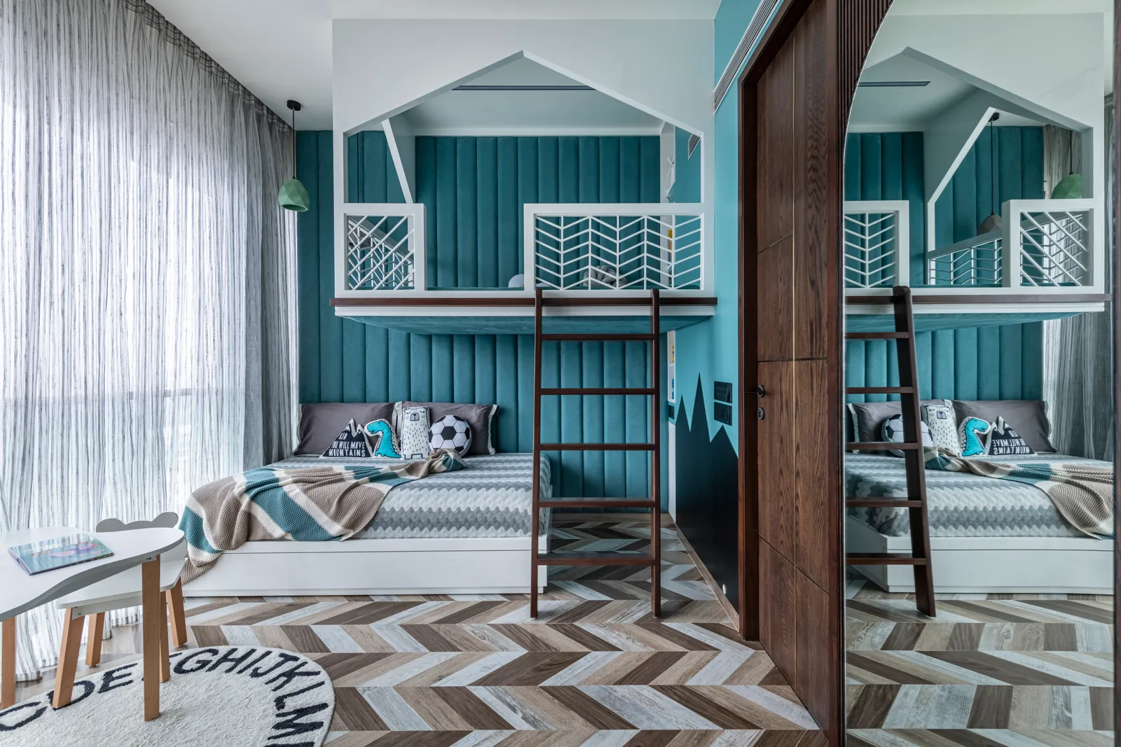 The shining star of the kids’ bedroom is the playhouse above the bed. The big teal headboard is balanced by abstract wallpaper and chevron flooring. PRASHANT BHAT