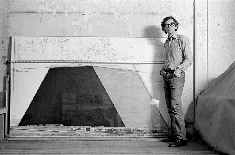 Christo in his studio with a preparatory drawing for The Mastaba, New York City, 1984. Photo: Wolfgang Volz © 1984 Christo and Jeanne-Claude Foundation